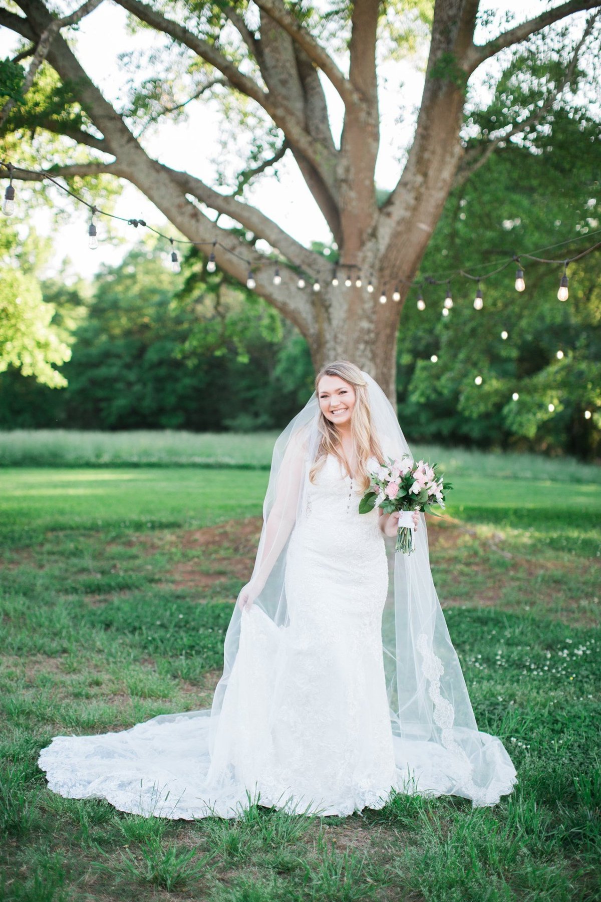 Wedding Photographer, bride standing under a tree