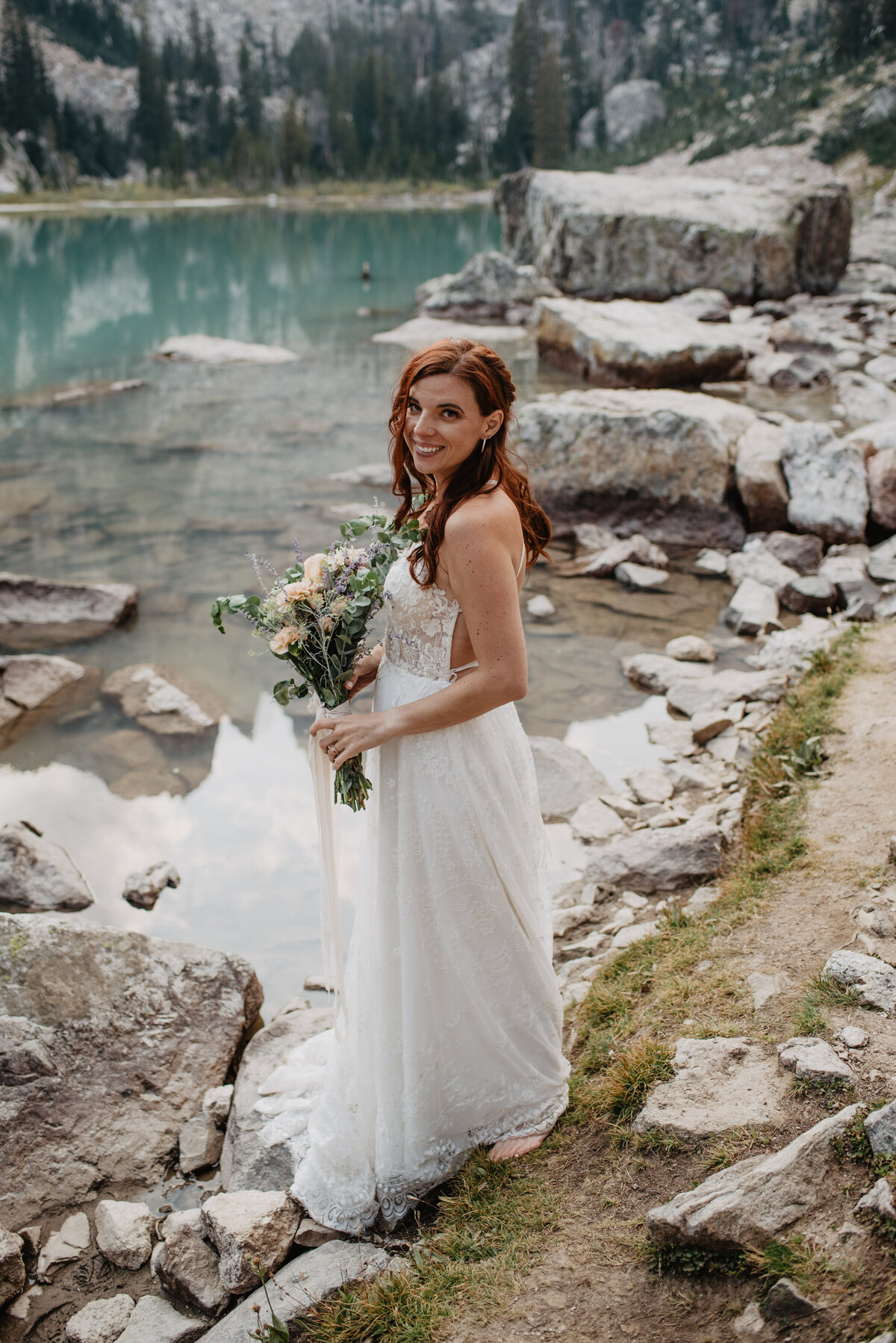 Jackson Hole Photographers capture bridal portrait of bride holding bridal bouquet