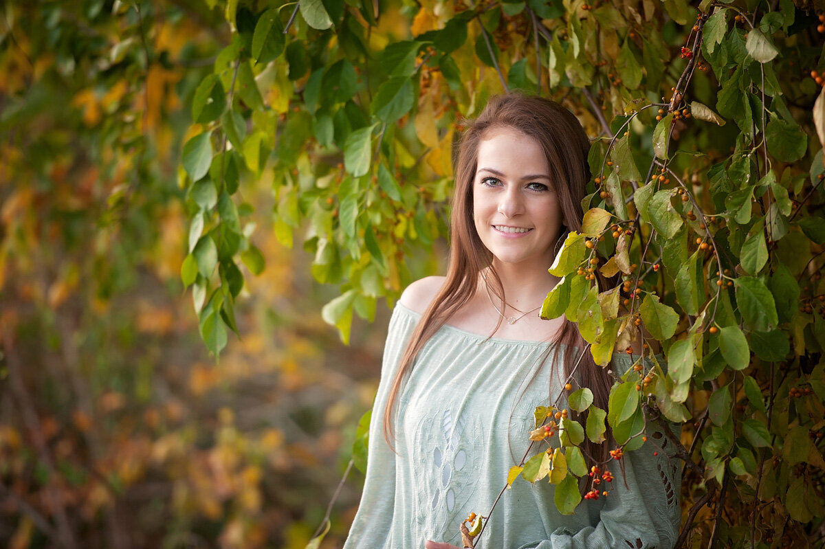 Senior session of young woman against a tree