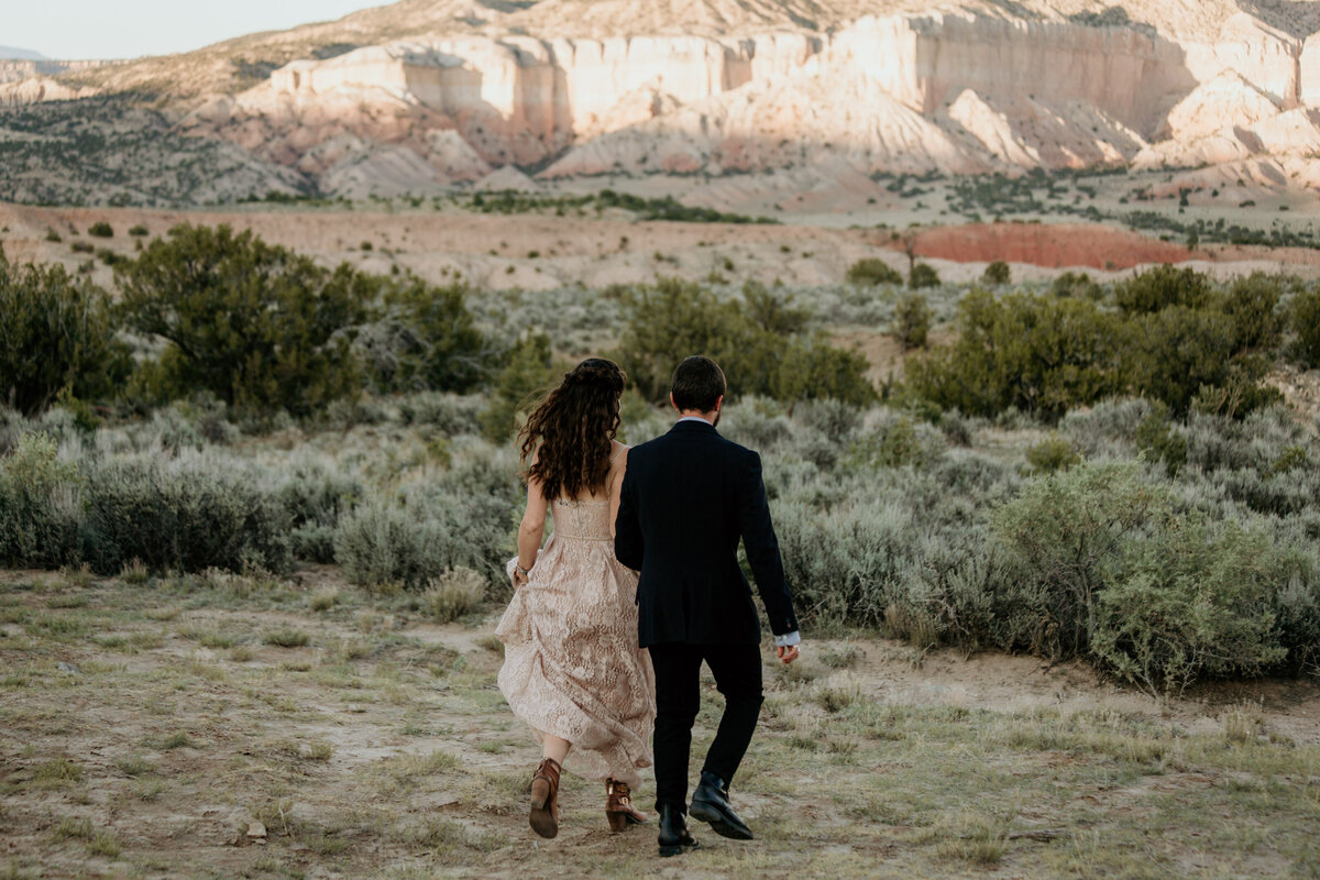 couple running away in the desert