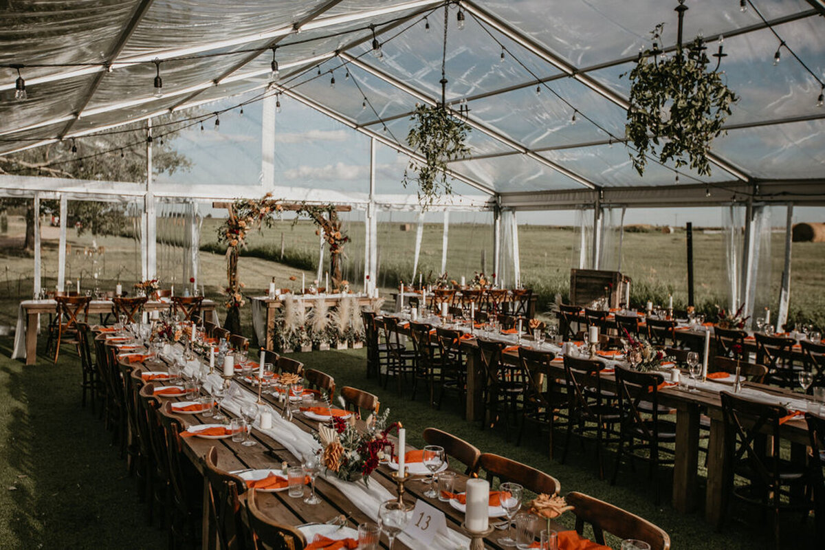 Elegant reception inside wedding tent at The Gathered, a nostalgic greenhouse based in Kathryn, Alberta wedding venue, featured on the Brontë Bride Vendor Guide.