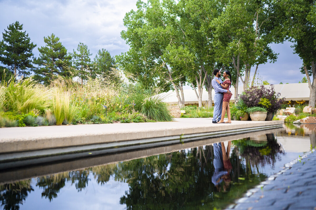 Surprise Proposal at Denver Botanical Gardens in red dress and dress clothes