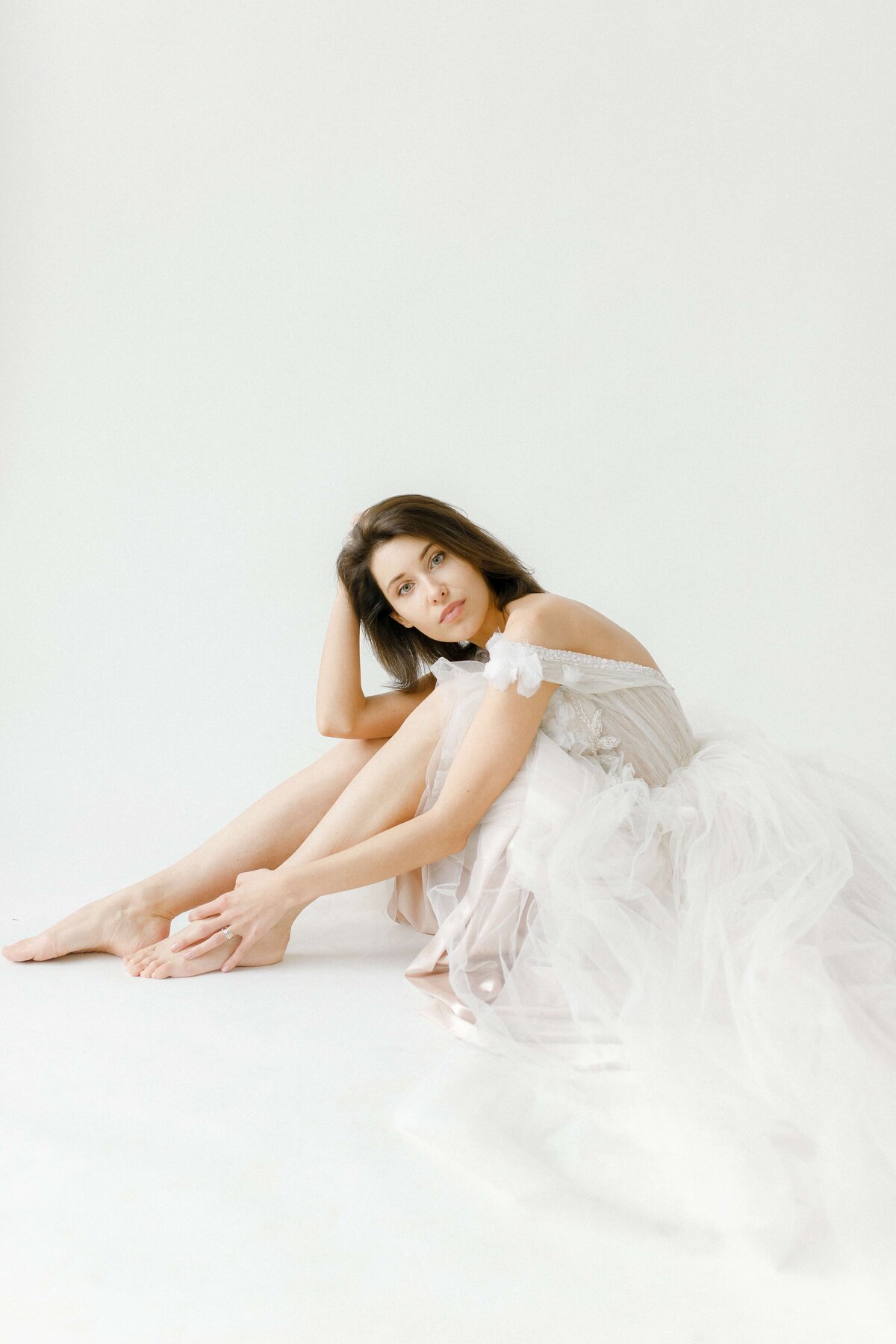 model-sitting-in-white-wedding-dress