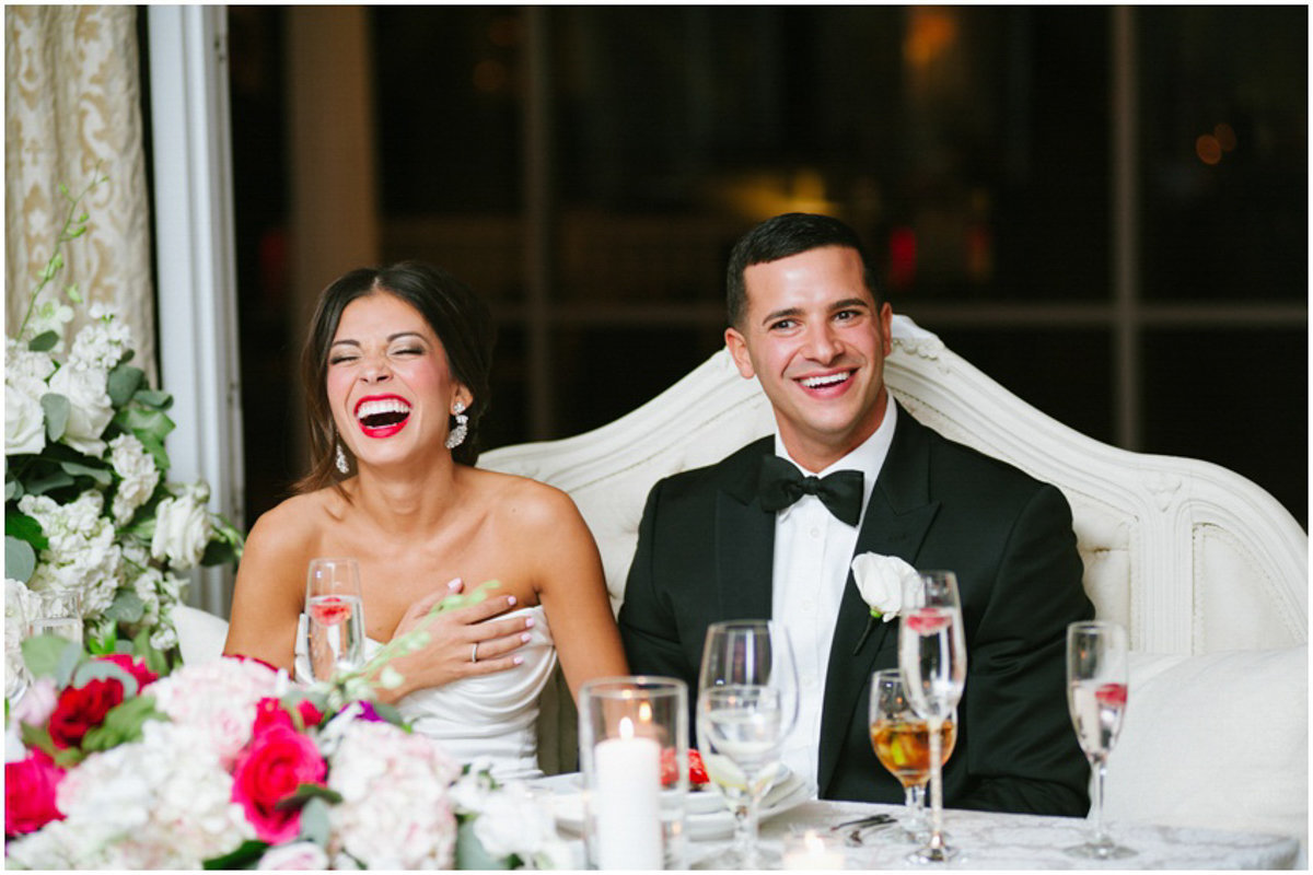 Couple laughing at their wedding toasts at mallard Island