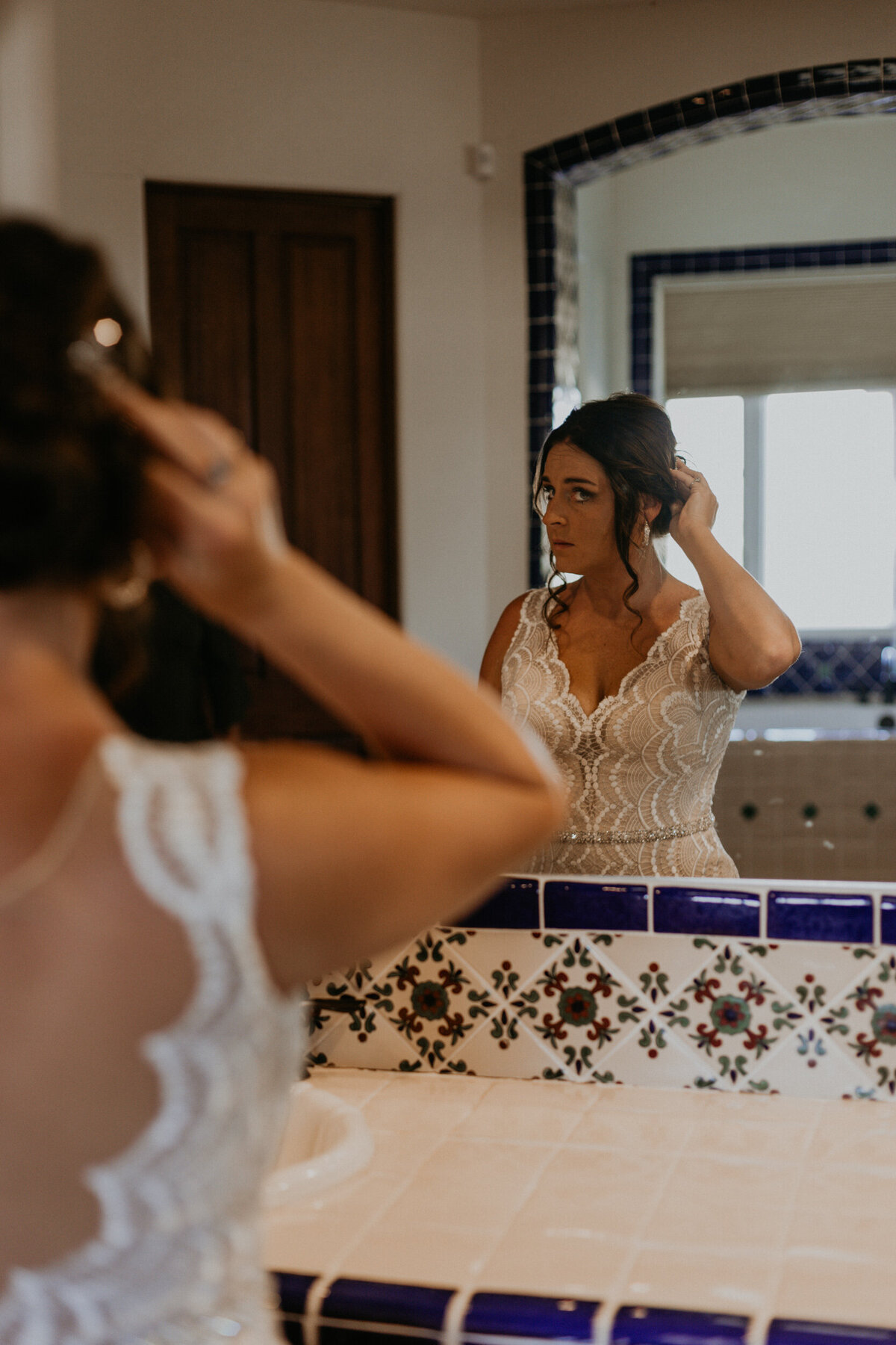 bride getting ready in a southwestern styles bathroom