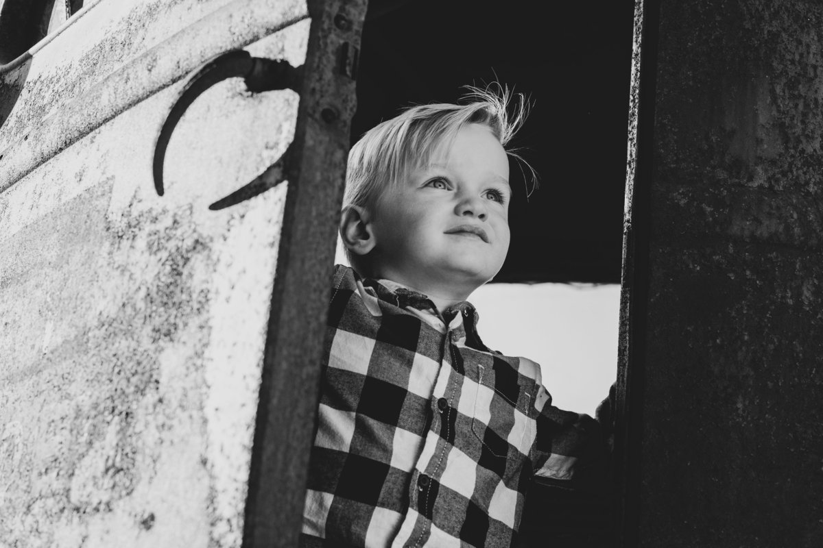 black and white of boy in truck