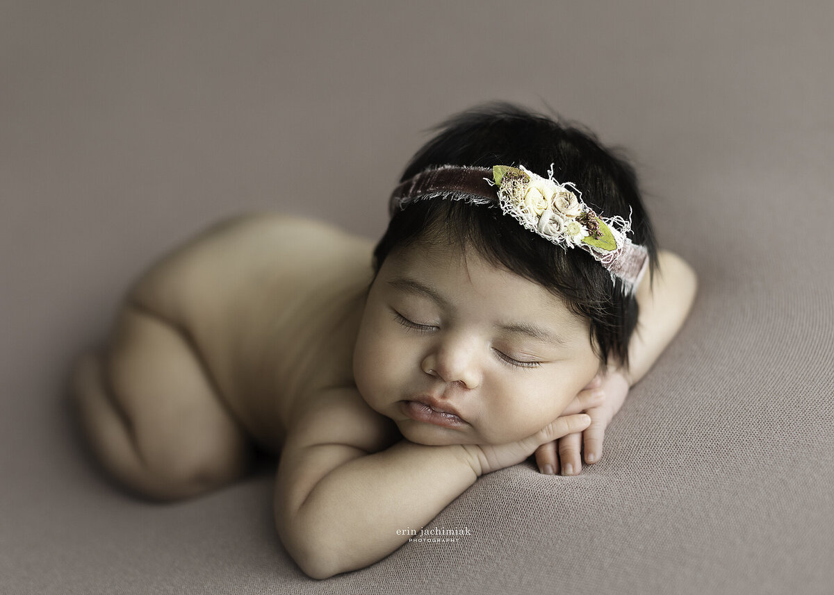Baby girl sleeps for newborn photos in Denver photography studio