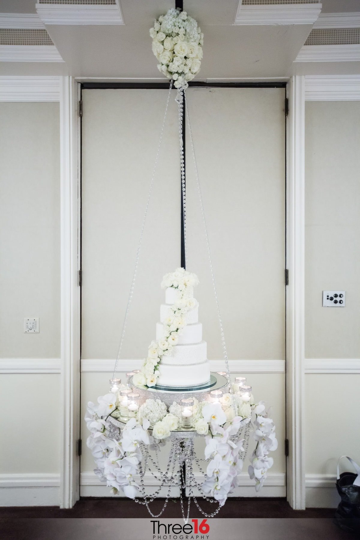Amazing 5-tiered white wedding cake on display at the wedding reception