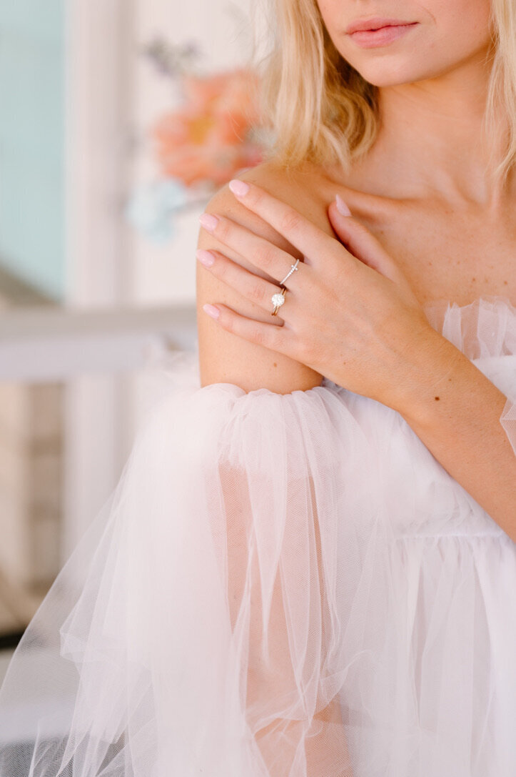bride posing with her hand on her shoulder