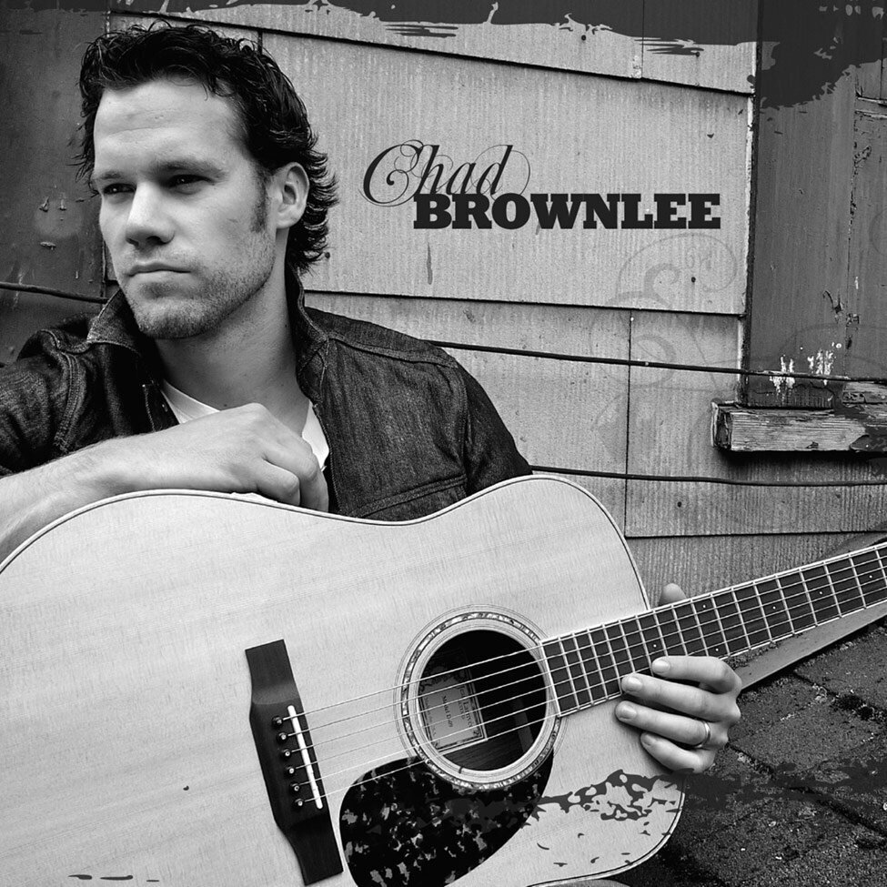 Country Music Album Cover Self Titled Artist Chad Brownlee sitting against barn acoustic guitar in lap black and white image