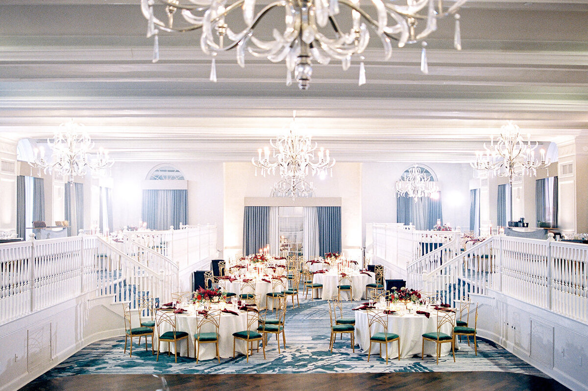 Luxurious reception room at Don Cesar Hotel, St. Pete Beach, FL, featuring dazzling crystal chandeliers and a beautifully arranged event setup.