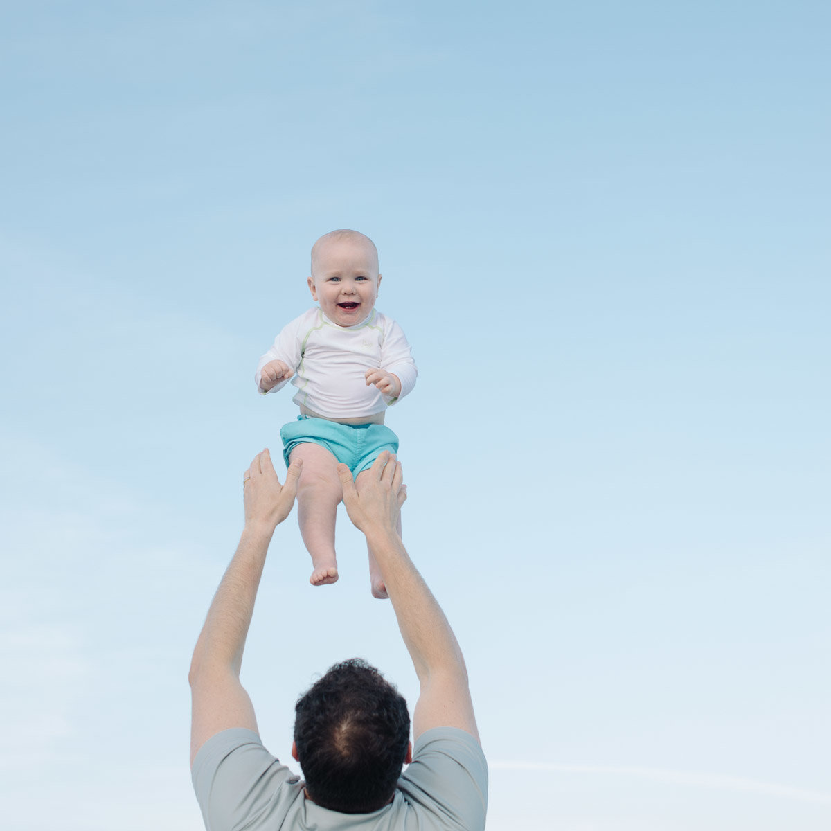 baby being tossed in the air