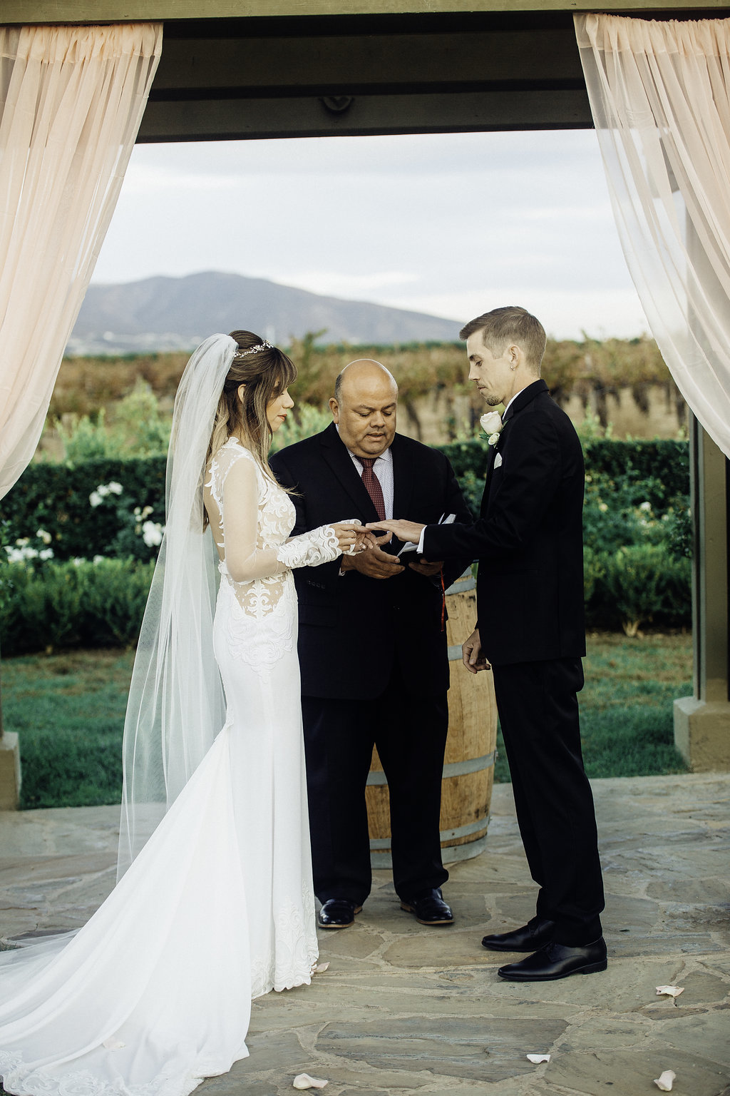 Wedding Photograph Of Bride Giving The Ring To His Groom Los Angeles