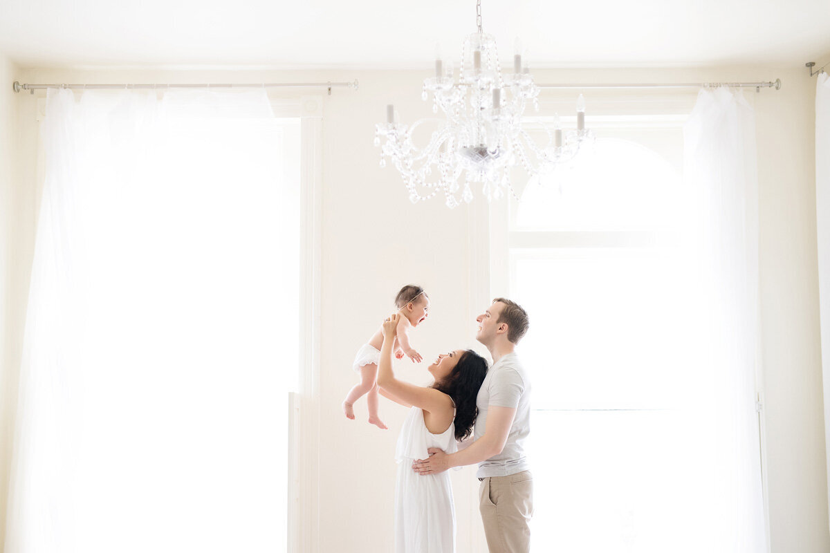 Family session of little girl and her parents in home