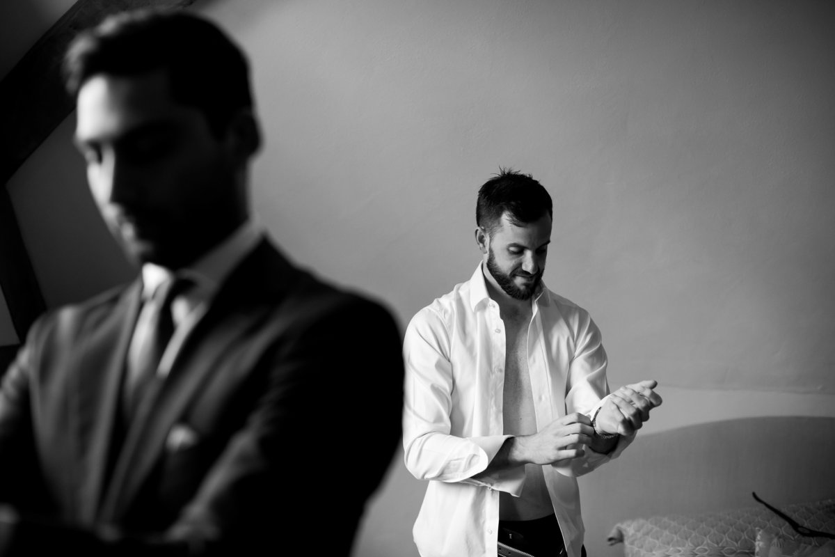 Groom getting ready in black and white at The Oak Barn in Devon