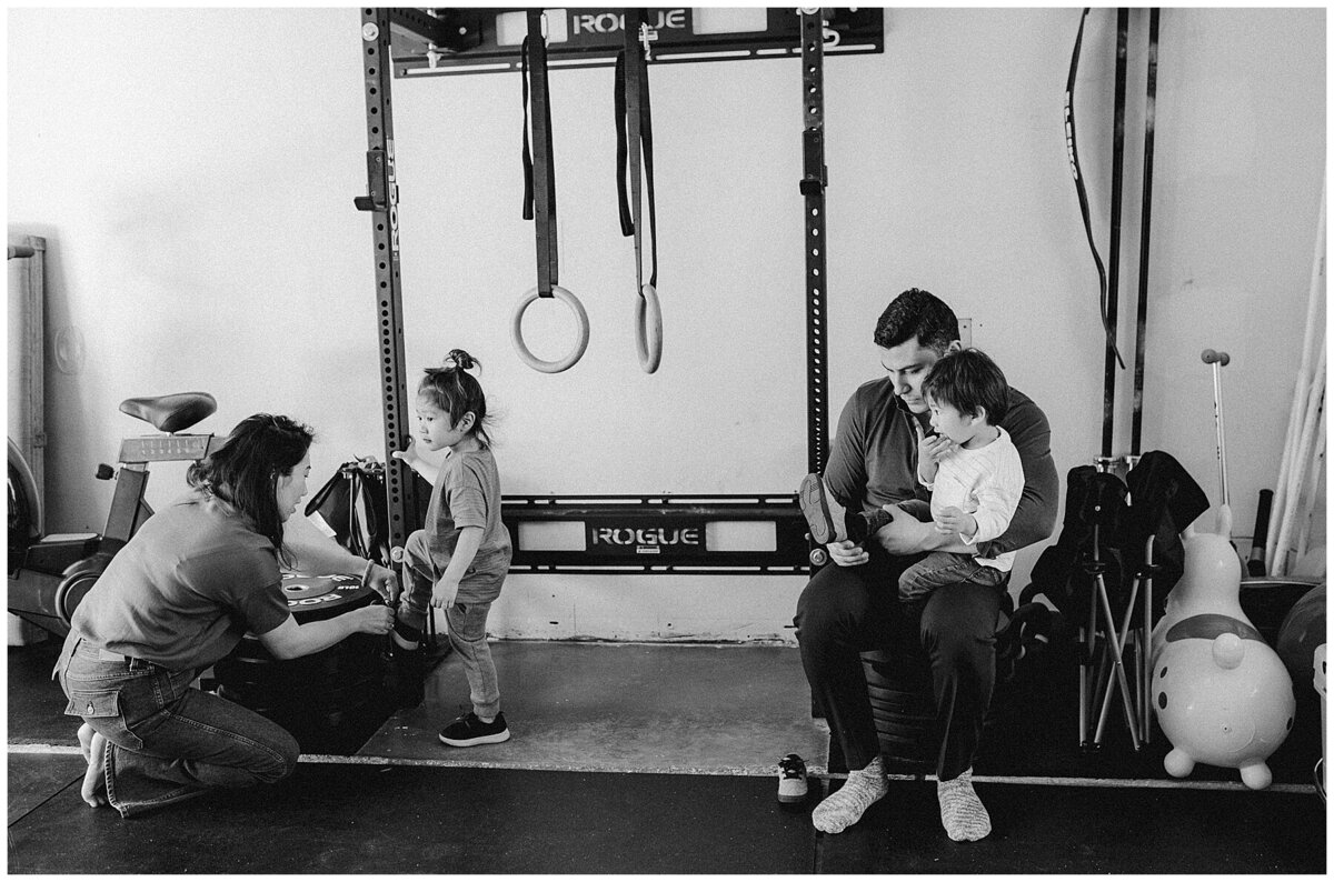 Family with two children inside gym room at family photo session in Austin by Amber Vickey Photography