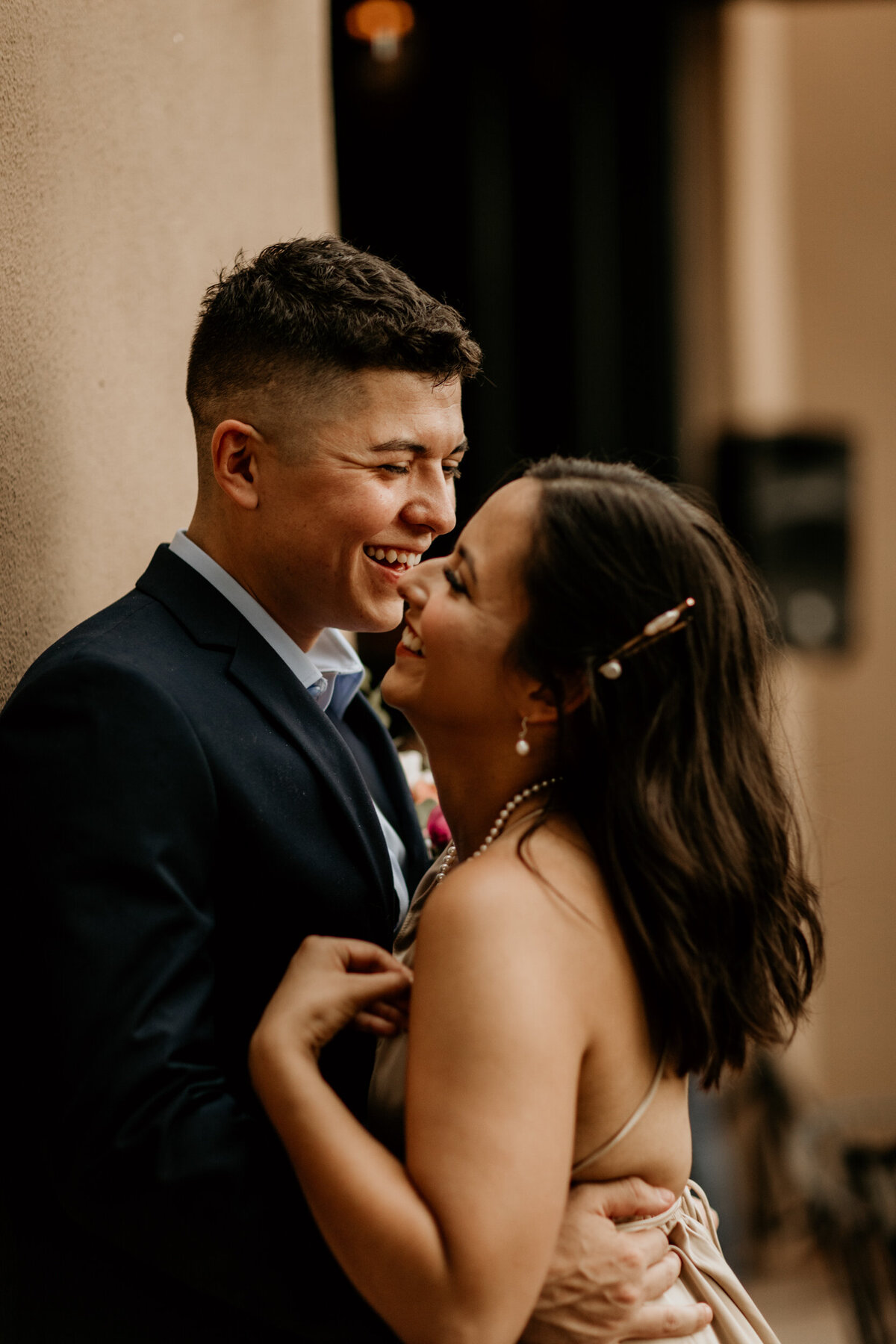 newlyweds laughing and holding each other downtown