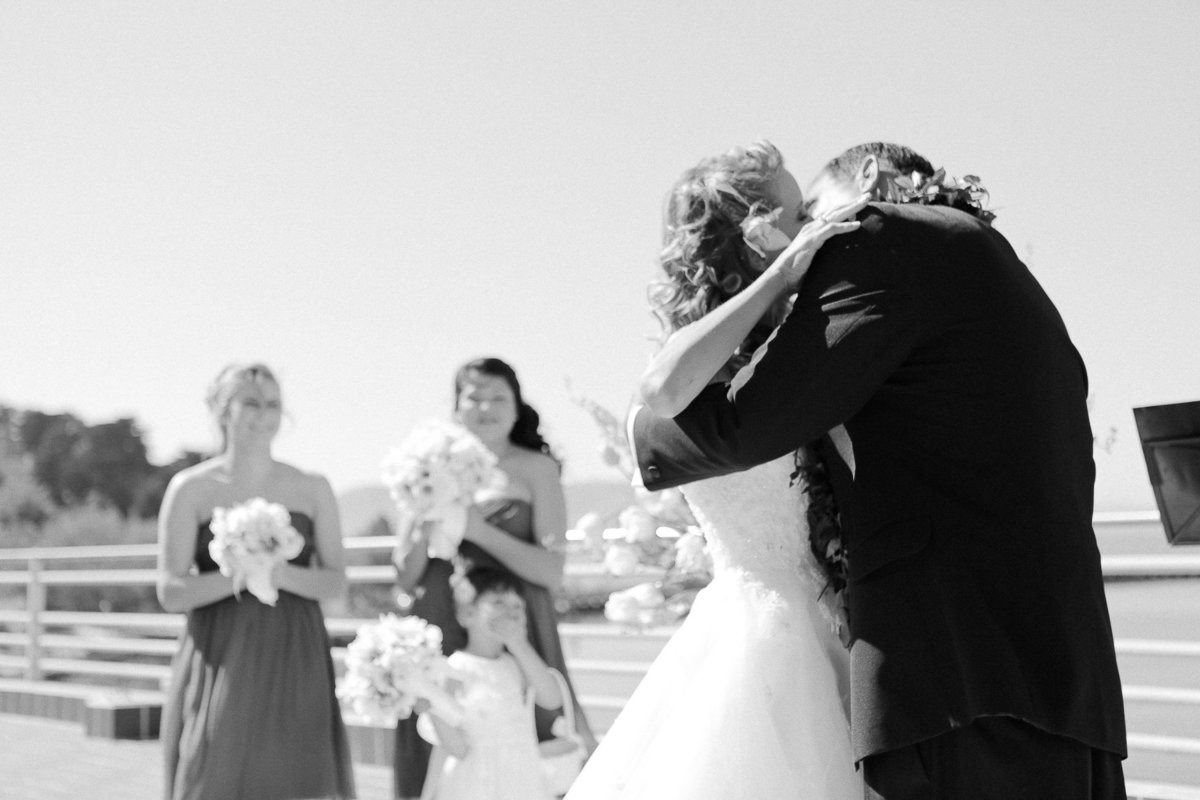 Outdoor wedding kiss during a ceremony at the Maritime Museum in San Francisco.