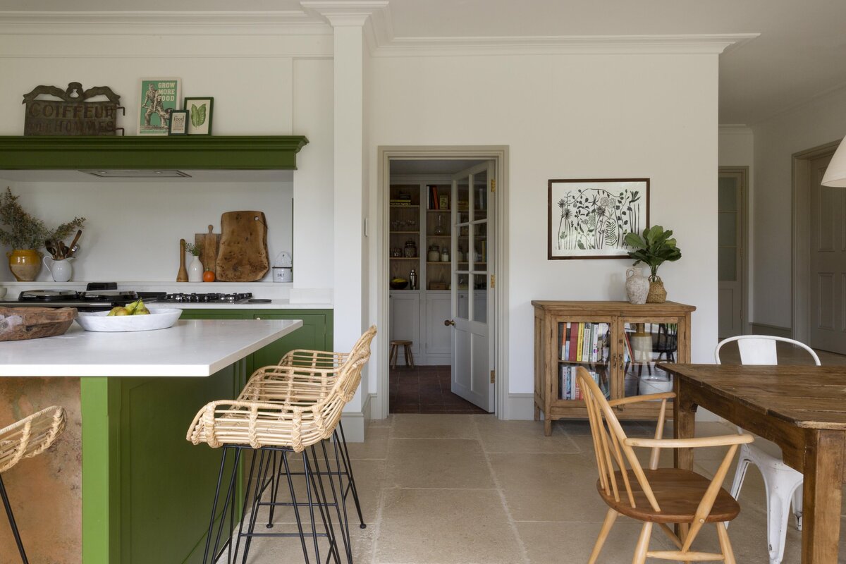 Entranceway into kitchen with dining area to the right and worktop to the left