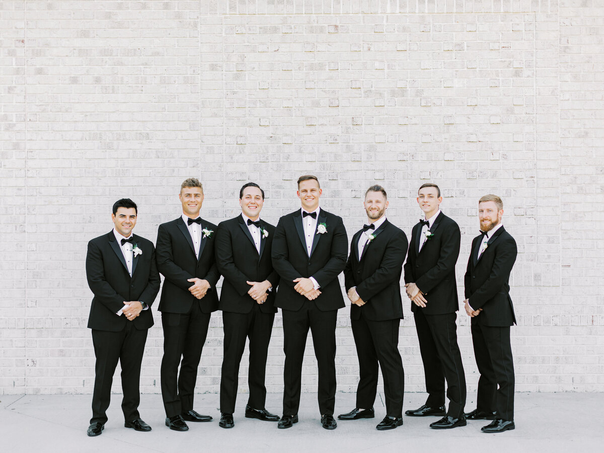 groomsmen in black suits
