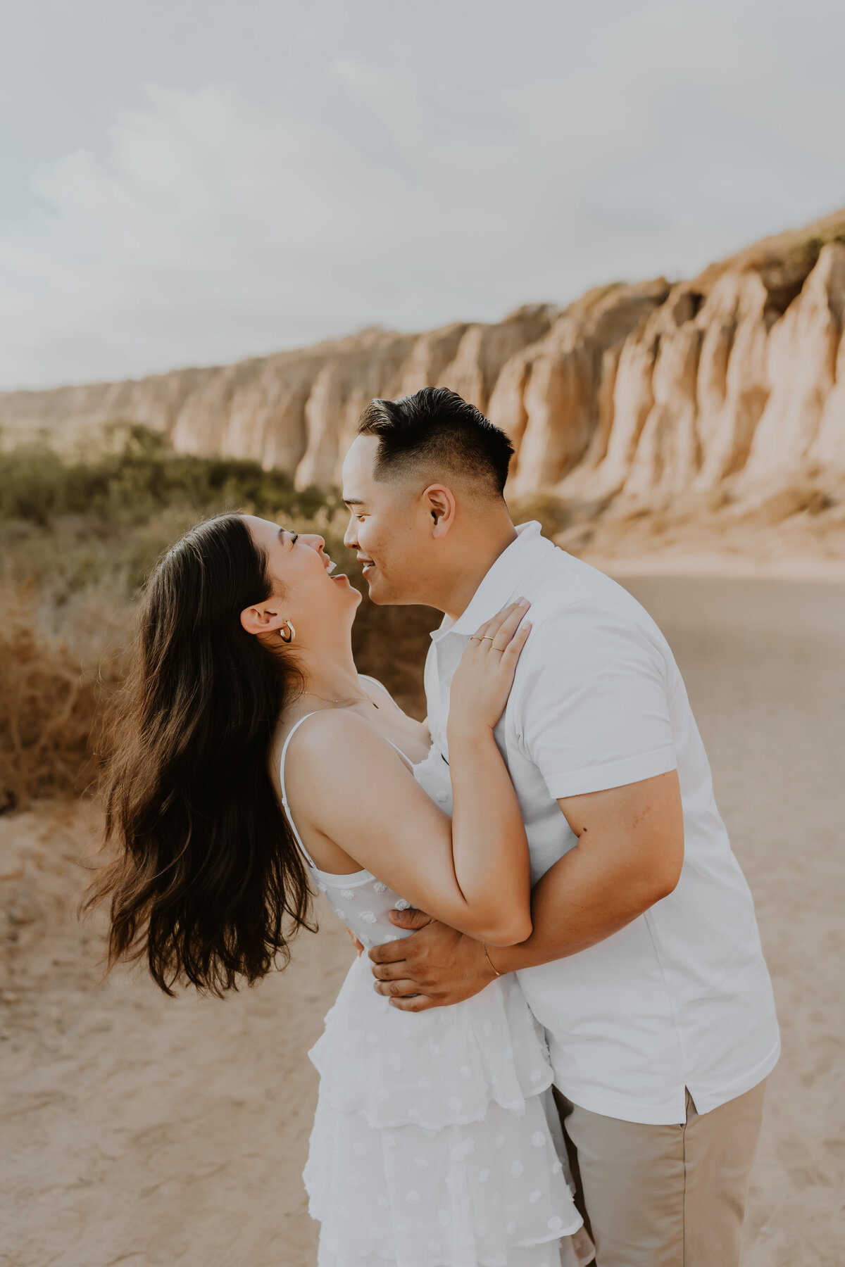 man holds woman in engagement photoshoot
