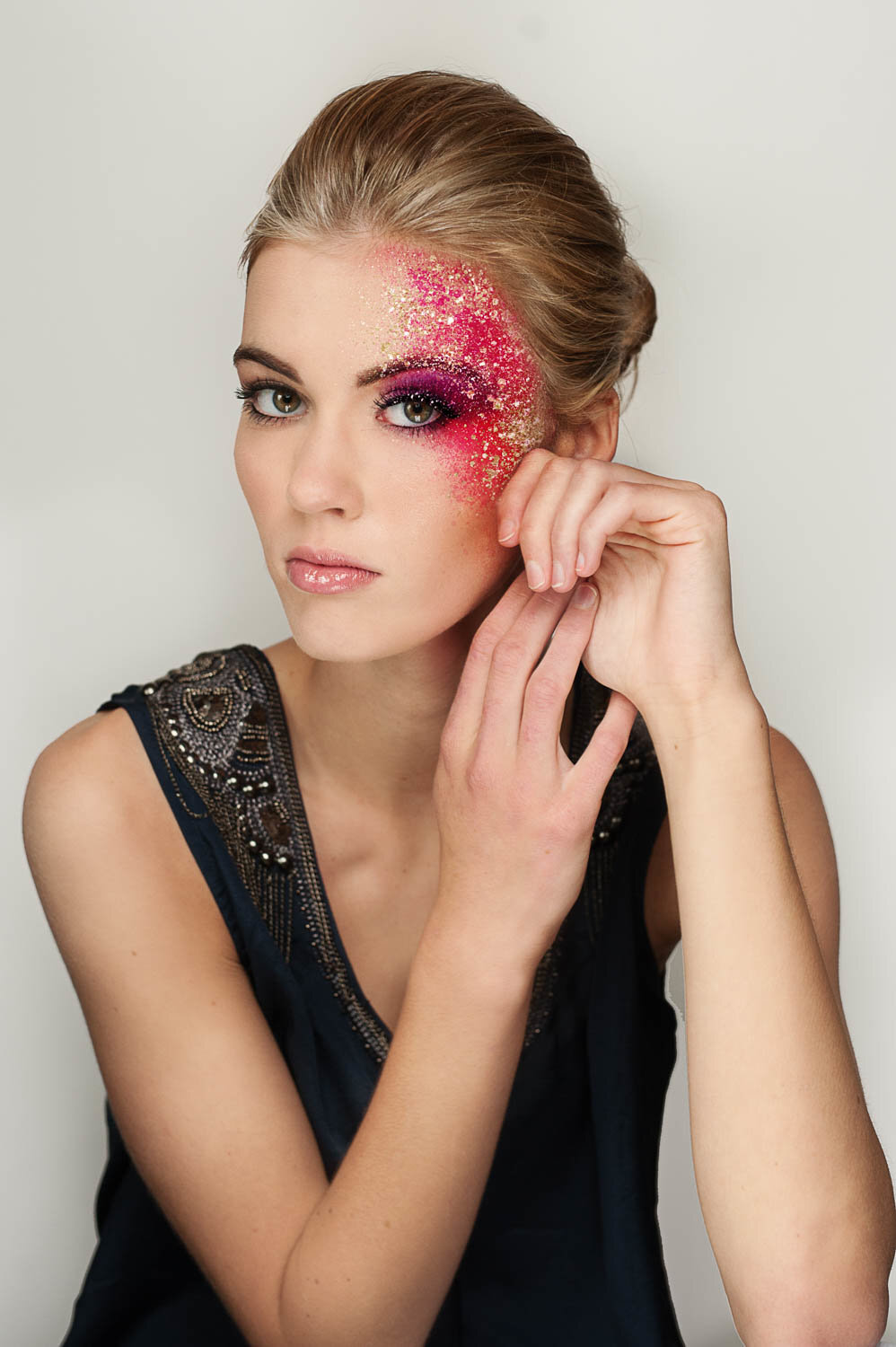 professional makeup artist photo of senior with glitter and colorful makeup