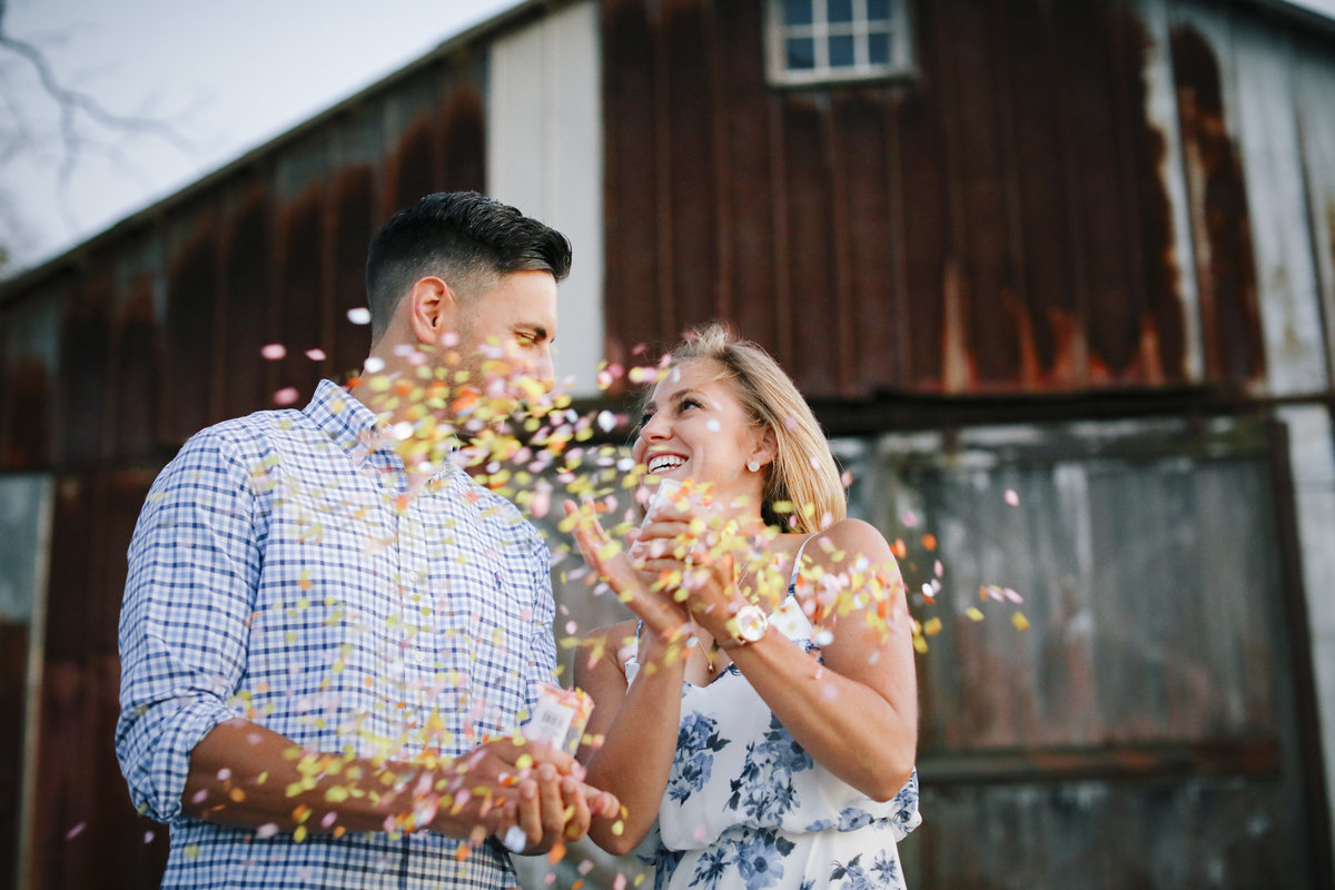 engaged couple pops confetti at laurtia winery