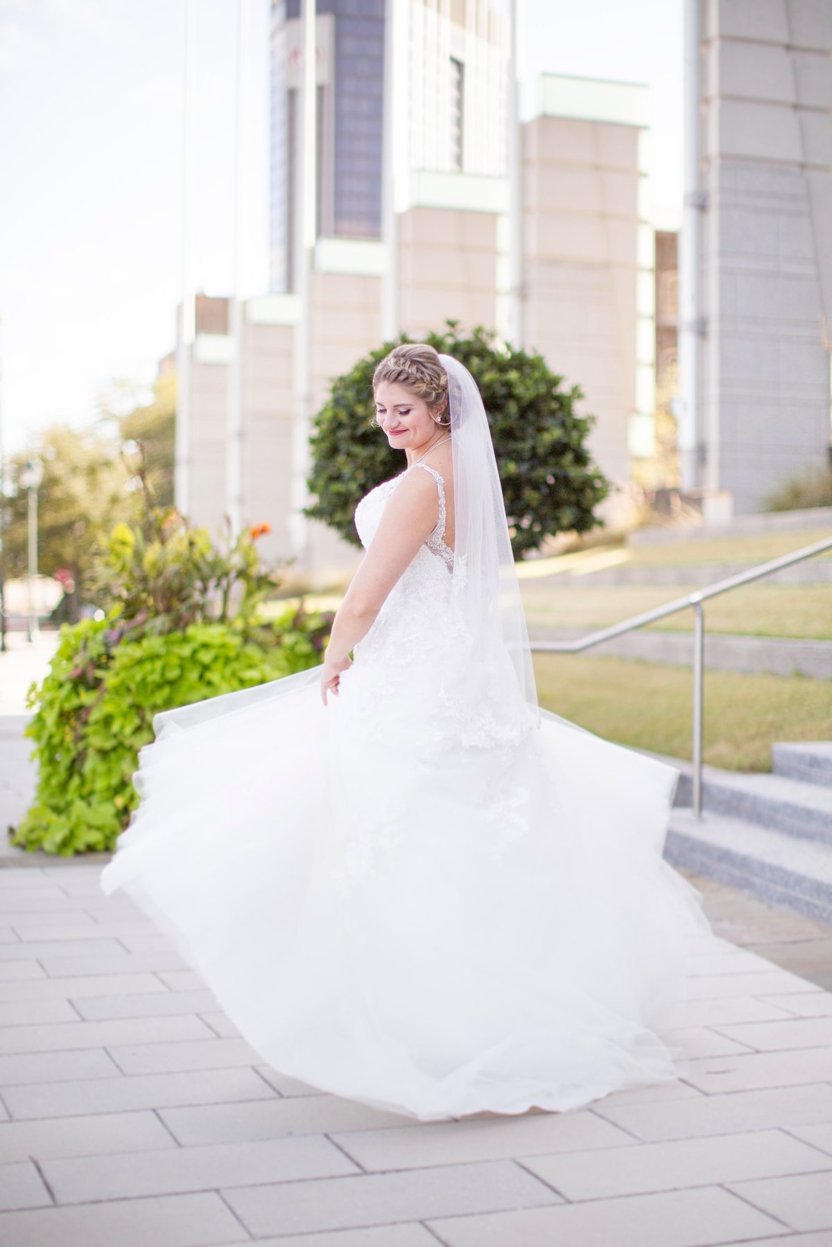The bride twirls in her dress during the bridal session at The Battle House Hotel in Mobile, Alabama.