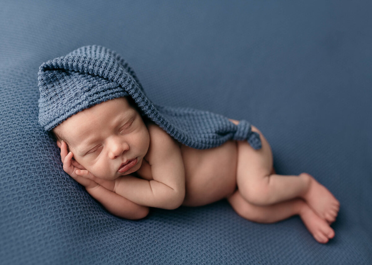 Baby boy in blue with sleepy cap
