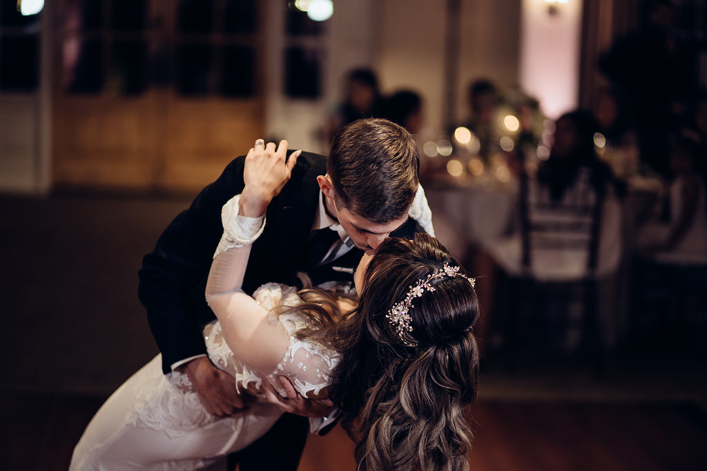 Wedding Photograph Of Bride And Groom Bending While Dancing Los Angeles