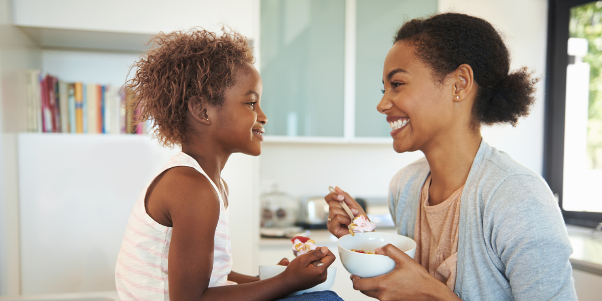 Image Thrive by Spectrum Pediatrics image for home page is a child happily eating with mother during mealtime