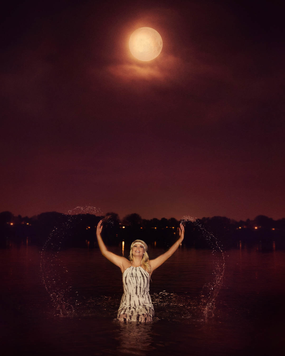 high school senior in lake at night with full moon