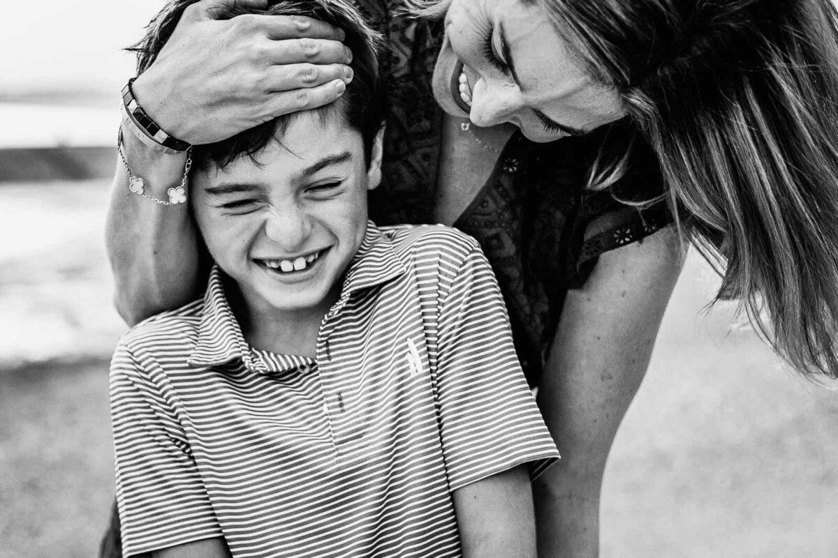 mom and son laughing on beach during long island family photo session