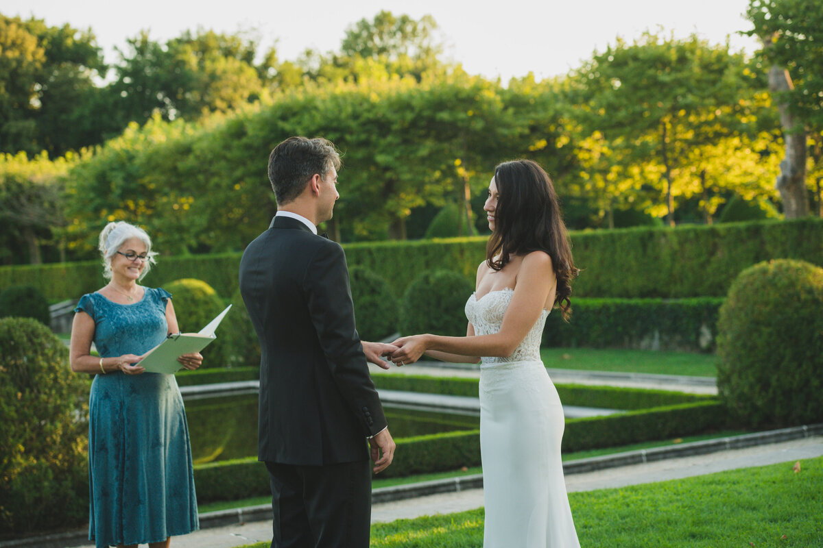 bride and groom exchanging vows outside Oheka Castle
