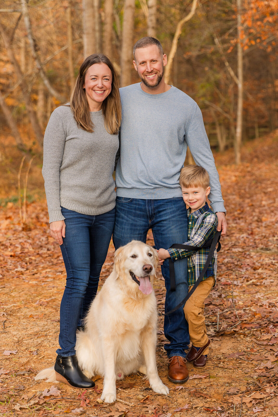 Family stadnging on a path during winte photo session with their toddler boy and dog in Atlanta by Laure Photography