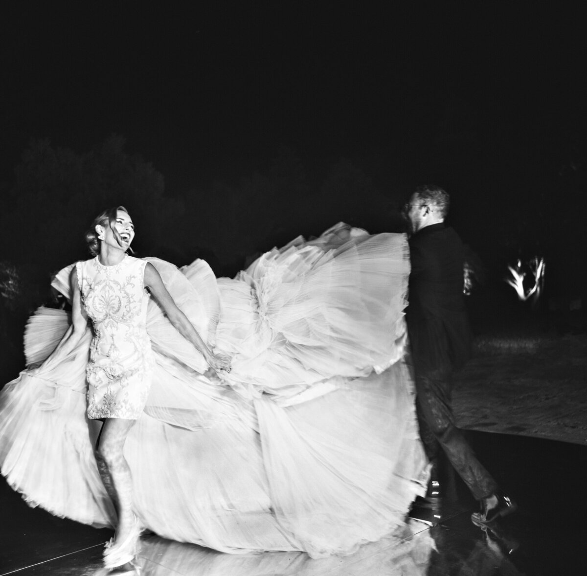 Bride with couture wedding dress and groom dancing