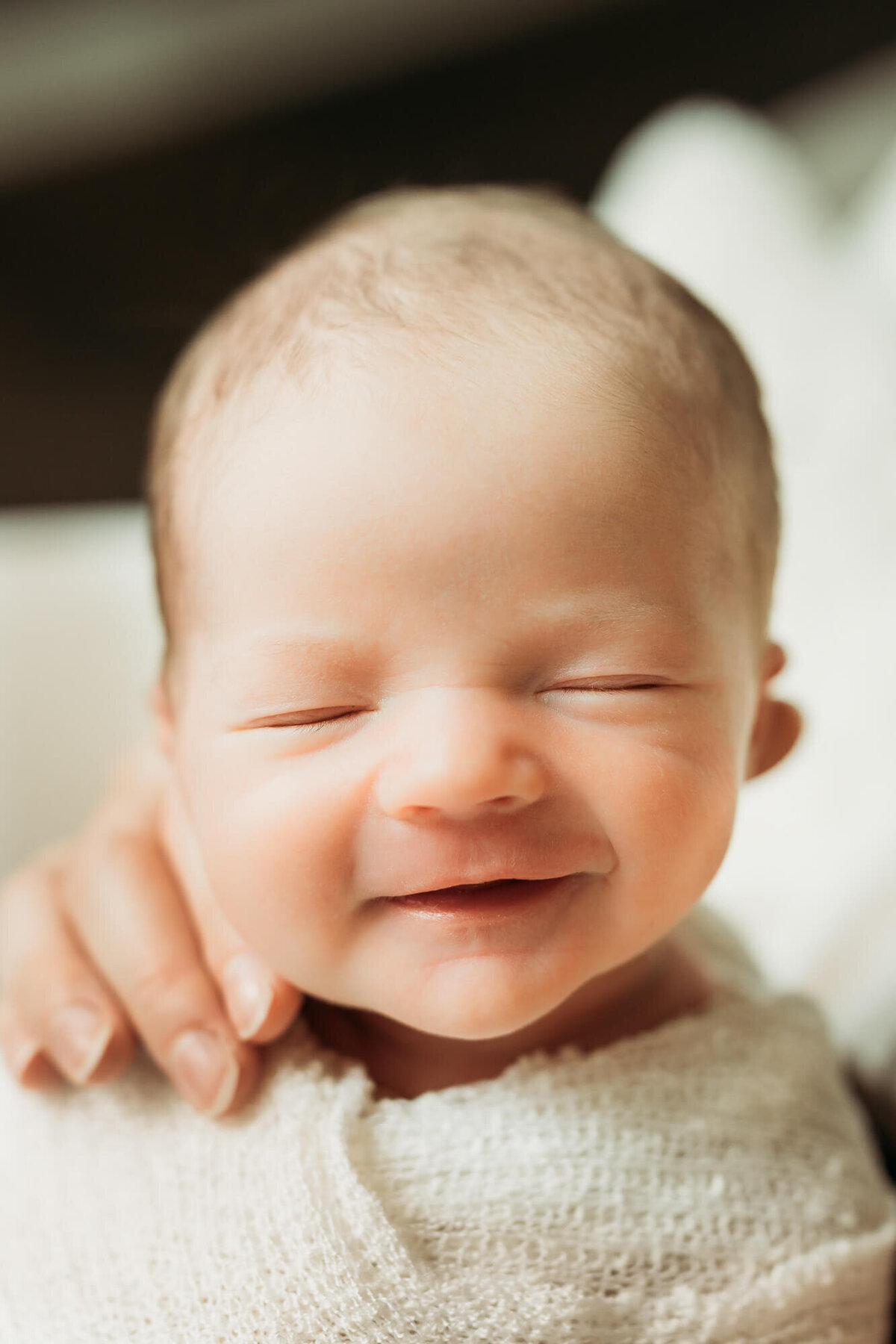 Smiling newborn baby boy at in home newborn session in Houston, Texas.