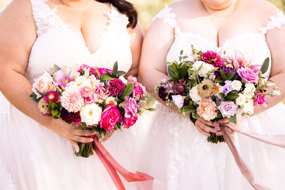Pink and purple wedding bouquets held by brides