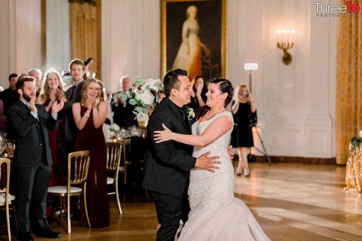 Bride and Grooms First Dance as guests stand and cheer them on