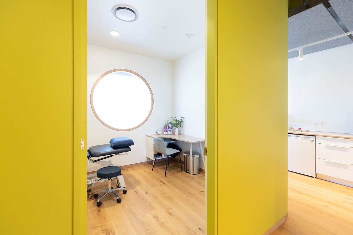 Interior of Papaya Clinic with the green walls and the big round window