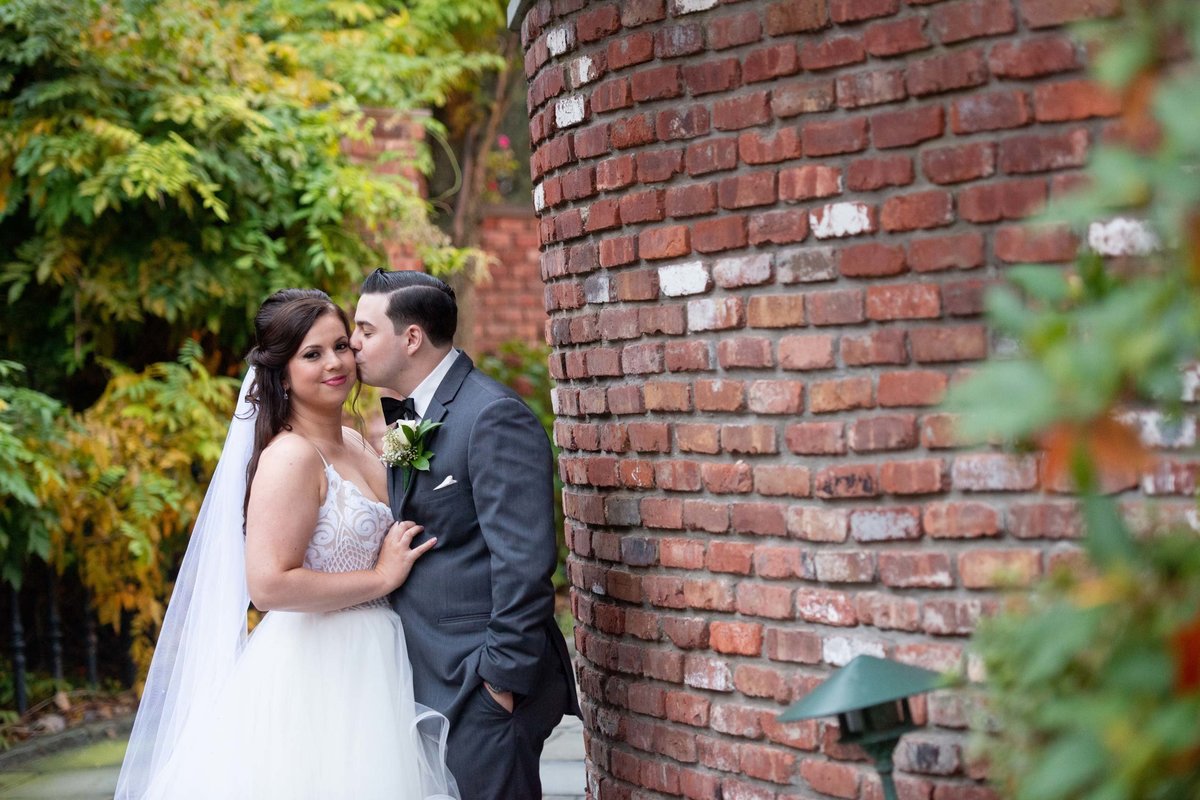 Groom kissing bride at Fox Hollow
