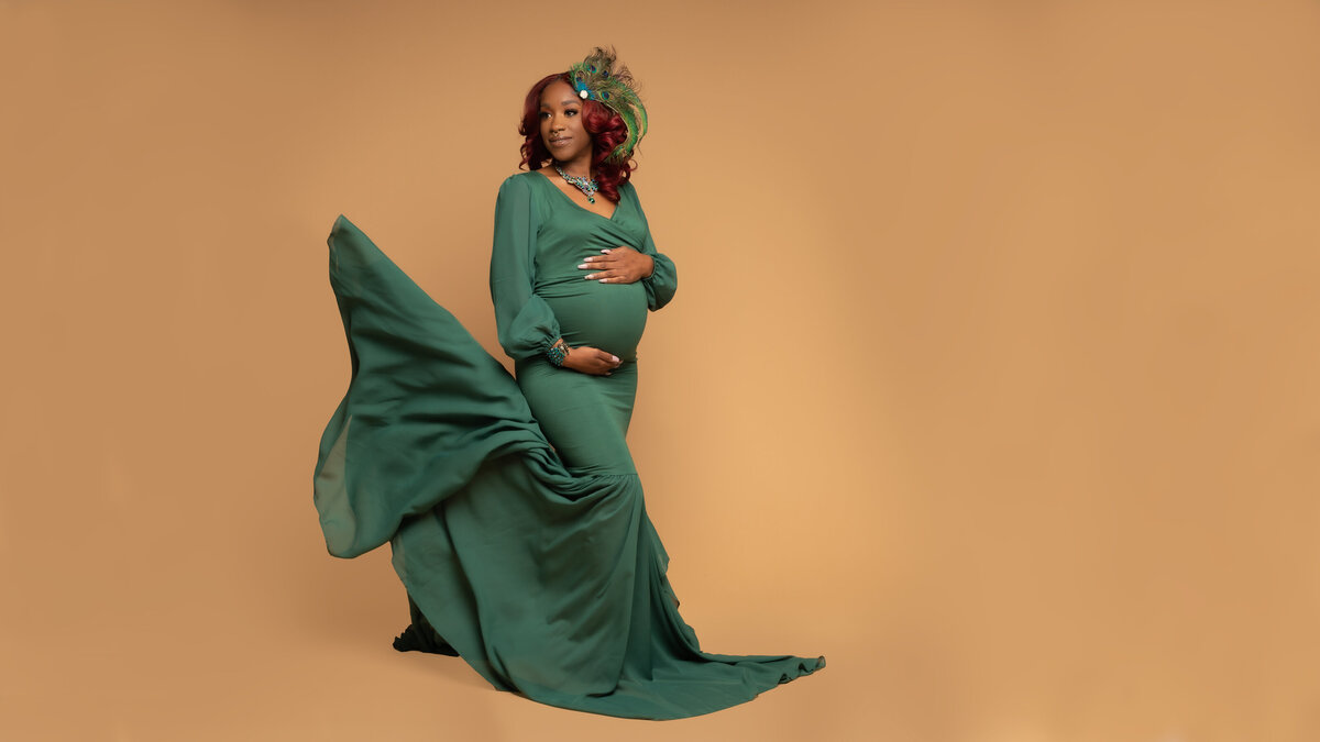Black pregnant mom to be in green dress
