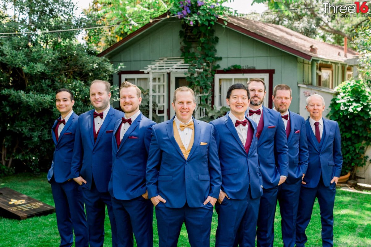 Groom and his Groomsmen pose for photos in their blue suits