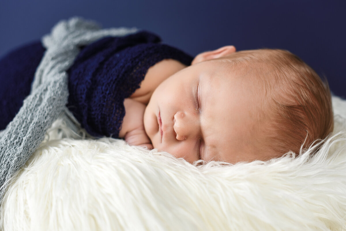 Beautiful Mississippi Newborn Photography: baby boy wrapped in navy sleeping