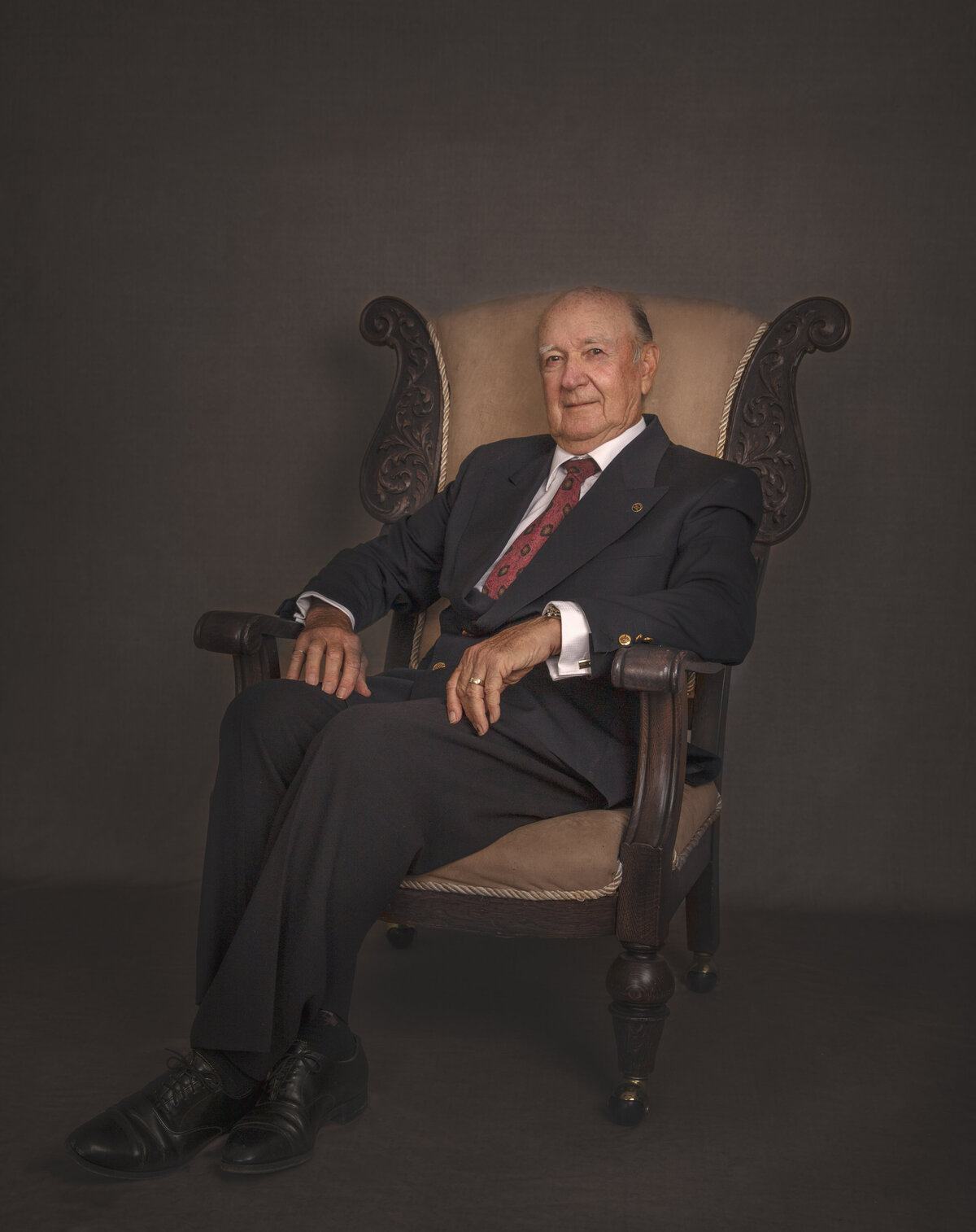 formal portrait of man sitting in a chiar with suit at Sonia Gouries fine art photography studio in Ottawa Ontario