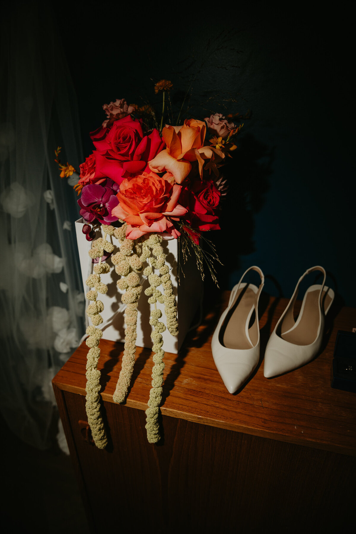 Brides wedding bouquet from FROG MCR sits on a mid century modern sideboard at Ducie Street Warehouse.