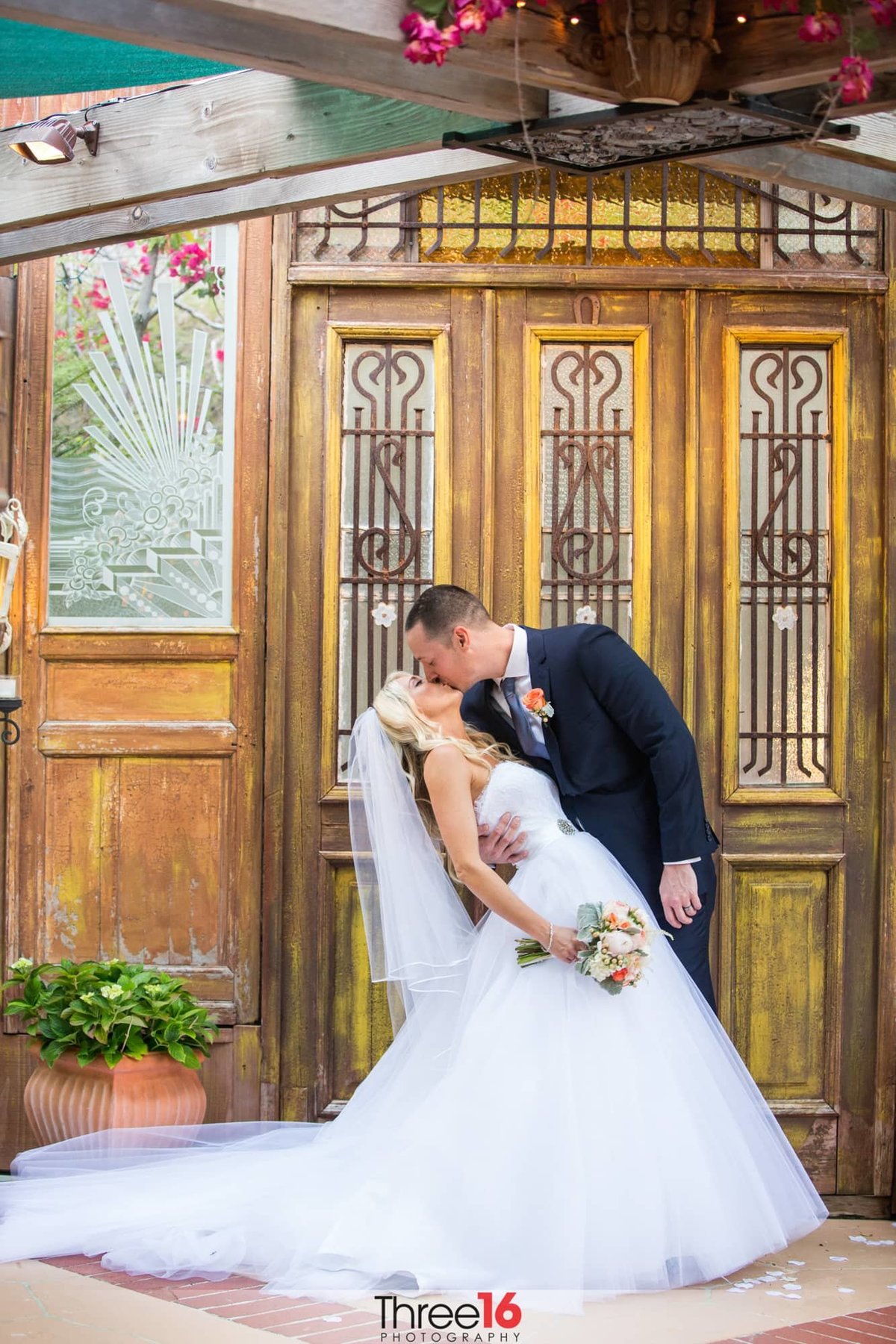 Bride gets dipped and kissed by her new Groom
