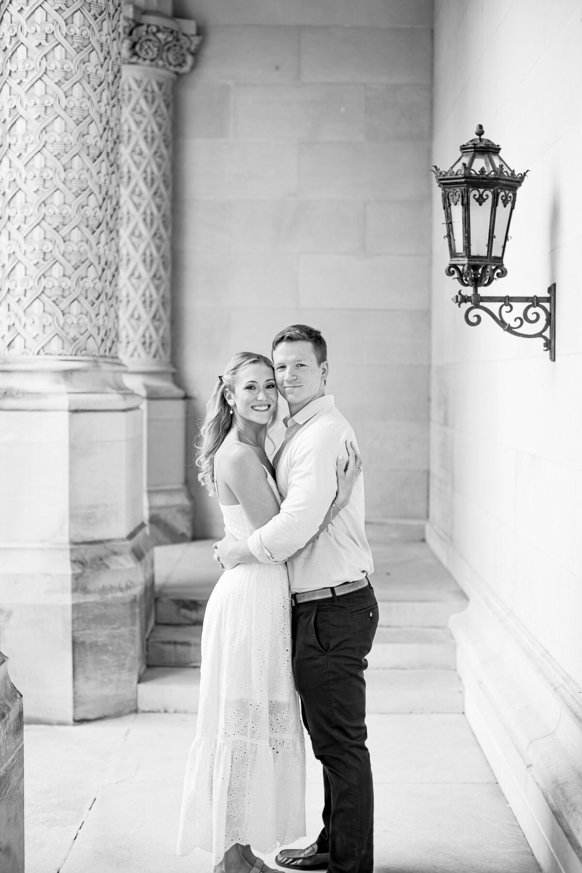 black and white photo of couple by columns