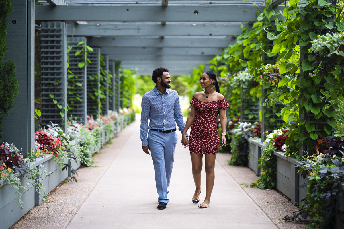 Surprise Proposal at Denver Botanical Gardens in red dress and dress clothes