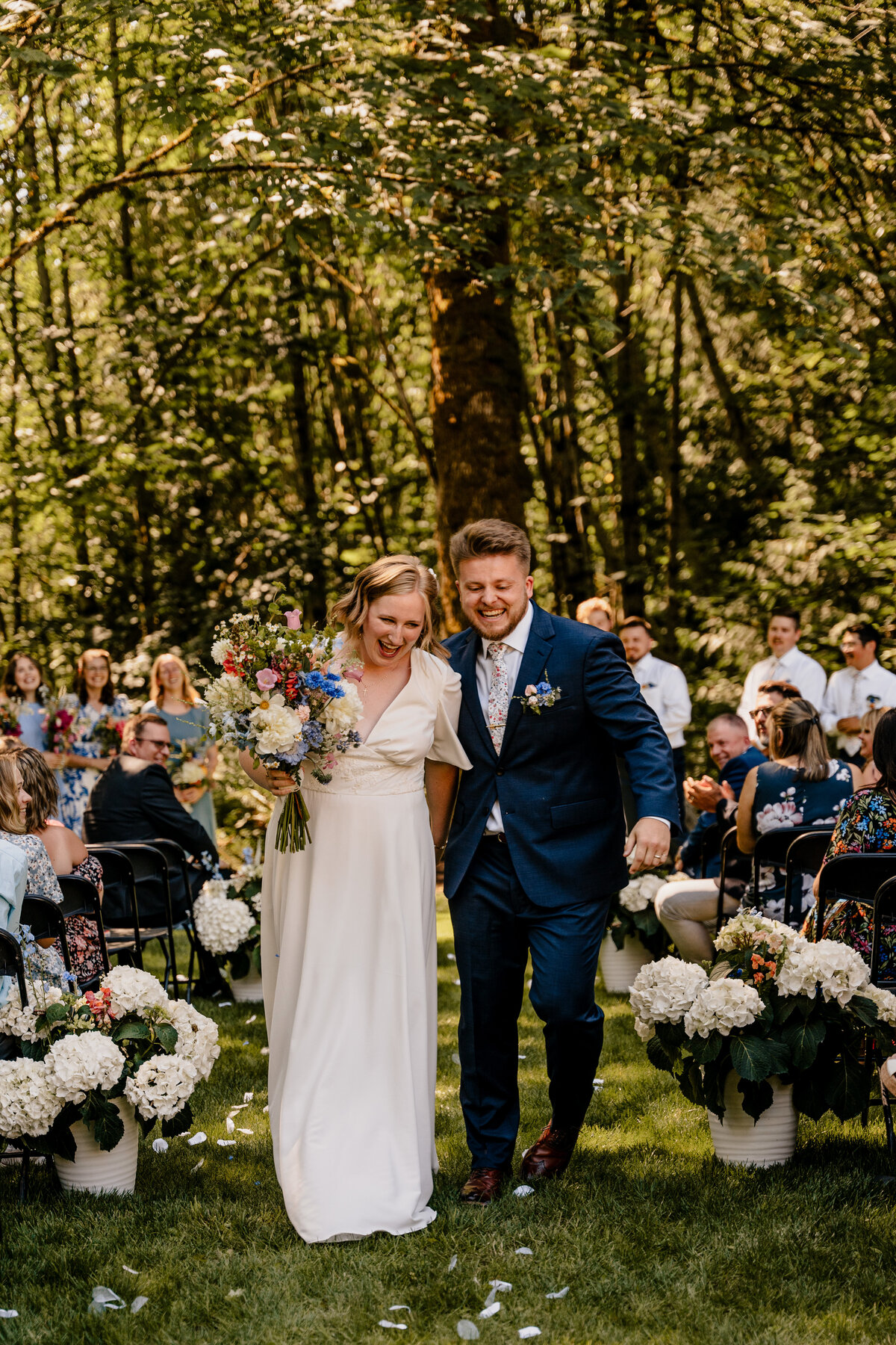 The bride and groom exit their ceremony full of excitement.